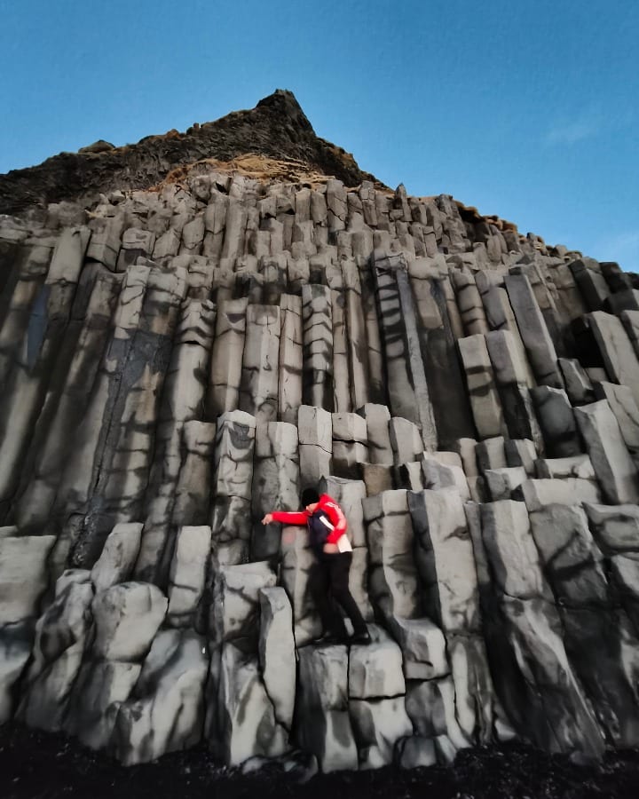 Attempting to climb the basalt columns in reynifsjara beach, Iceland